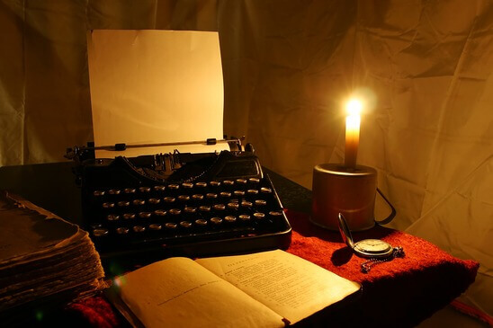candle, old typewriter and old book